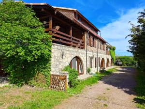 an old stone building with a tree at Marina Park Camping in Vama Veche