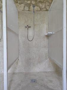 a shower with a glass door in a bathroom at Marina Park Camping in Vama Veche