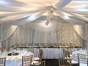 a banquet hall with tables and chairs and a ceiling at Mercure Clear Mountain Lodge in Mount Samson +84 photos
