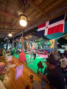 a group of people sitting at a bar playing bowling at Surfbreak Cabarete in Cabarete
