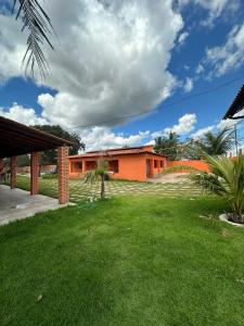a house with a green lawn in front of it at Pousada sonho real in Barreirinhas