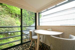 a room with a table and chairs and a window at Koyasan Shukubo Saizenin in Koyasan +108 photos