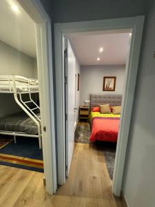a bedroom with a bed and bunk beds in it at Apartamento do Lagar, Praia da Abrela in O Vicedo