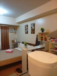 a small room with two beds and a desk at New Centrio Tower Lovely Studio adj Ayala CDO in Cagayan de Oro