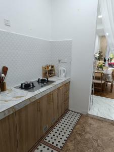 a kitchen with a counter and a stove in it at D'Berang Rumah Singgah in Kuala Berang +15 photos