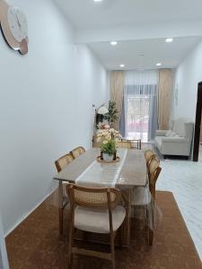 a dining room table and chairs in a living room at D'Berang Rumah Singgah in Kuala Berang