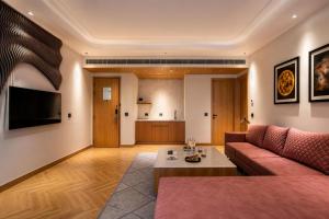 a living room with a couch and a table at Radisson Hotel Nathdwara in Nāthdwāra