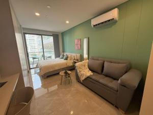 a living room with a couch and a bed at Edificio Reserva del Mar Bello Horizonte in Playa Bello Horizonte +83 photos