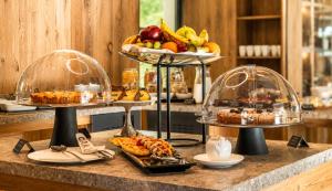 a buffet with two tiers of food on a counter at Paradise Lodge in Livigno