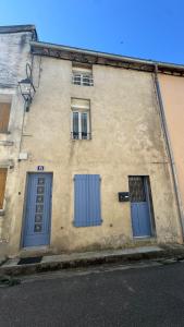 a building with two blue doors and two windows at Studio Mirepoix in Mirepoix