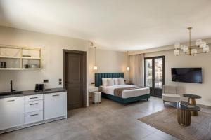 a bedroom with a bed and a living room at KANTADA central suite in Argostoli