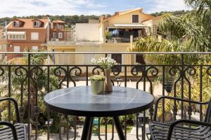a table on a balcony with a view of a city at KANTADA central suite in Argostoli
