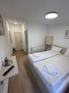 a bedroom with a white bed with blue towels on it at Domeniul La Mosie in Slimnic