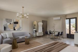 a living room with a couch and a table at KANTADA central suite in Argostoli +9 photos