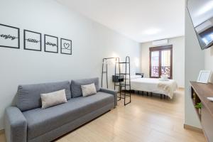 a living room with a couch and a bed at Oasis La Corredera, En Pleno Casco Histórico in Córdoba +71 photos