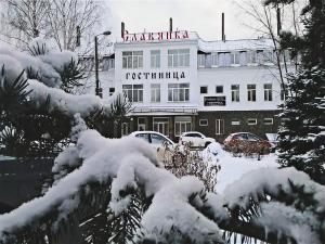 a building with a sign on it in the snow at Hotel Slavyanka in Nizhny Novgorod