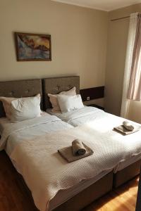 a bed with two hats and towels on it at Kapija Grada in Ečka