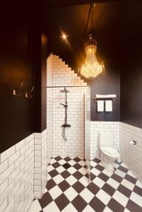 a bathroom with a toilet and a chandelier at Ludvigsdals Gård in Ystad +51 photos