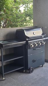 a barbecue grill sitting next to a table at " ARADA " Luxury House in Arad