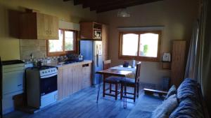 a kitchen with a couch and a table in it at Alma in Pinamar