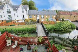 a backyard with a fence and a river at The Dover House with river and Castle views in Dover