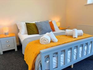 a bedroom with a bed with towels on it at The Dover House with river and Castle views in Dover