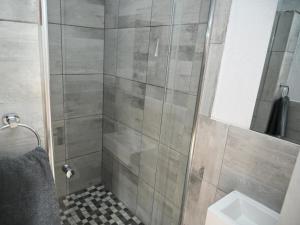 a bathroom with a shower with a toilet and a sink at Gae Ga Monare Guest House in Burgersfort