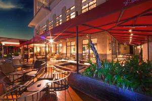 a building with a patio with tables and chairs at De Paviljoen Bandung in Bandung