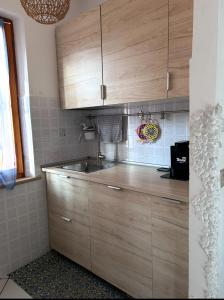 a kitchen with wooden cabinets and a sink at daNilomare in Marcelli