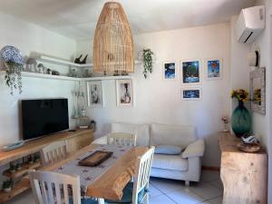 a living room with a table and a television at daNilomare in Marcelli +9 photos