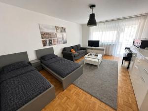 a living room with two beds and a couch at Pulheim Living 6 in Pulheim