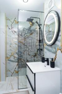 a bathroom with a sink and a mirror at Joy Apartament in Nehoiu +5 photos