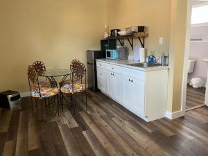 a kitchen with a table and chairs and a sink at MacGregors But and Ben in Pictou