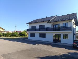 a white house with a balcony on the side of it at Prenociste Gradiska in Bosanska Gradiška