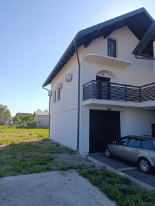 a car parked in front of a building with a garage at Prenociste Gradiska in Bosanska Gradiška +9 photos
