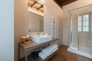 a bathroom with a sink and a shower at Hotel Cittadellarte in Biella