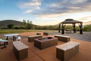 a patio with a gazebo and tables and benches at Tombstone Grand Hotel, a Baymont by Wyndham in Tombstone
