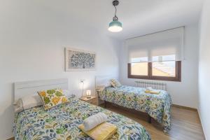 a bedroom with two beds and a window at Chalet Pinara in El Barraco +30 photos