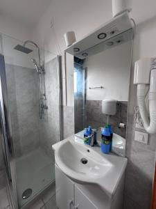 a white bathroom with a sink and a shower at Venice Night 11 in Mestre