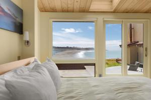 a bedroom with a bed and a view of the ocean at Pacific Bliss Haven in Gualala