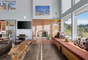a living room with a large couch and a fireplace at Pacific Bliss Haven in Gualala +41 photos