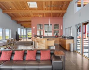 a living room with a couch and a kitchen at Pacific Bliss Haven in Gualala