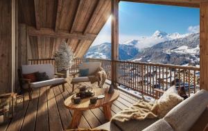 a room with a balcony with a view of mountains at TERRESENS - Les Balcons de Juliette in Notre-Dame-de-Bellecombe