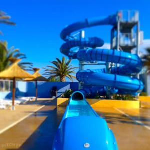 a blue water slide at a water park at Mobilhome, Camping Le Marisol in Torreilles