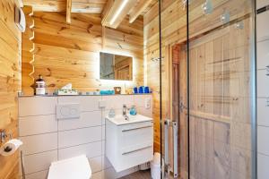 a bathroom in a log cabin with a sink and a shower at Adler Sommerhaus Oderwitz in  Oderwitz +14 photos