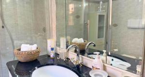 a bathroom with a sink and a mirror at The Light House - Olbia centro in Olbia