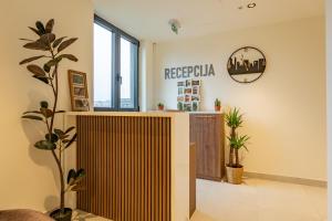 a lobby with a reception desk in a building at Hotel Eterna Hill Rooftop in Sajmište