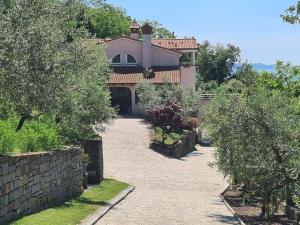 a large house with a stone walkway in front at Alloro in Ankaran