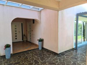 a hallway of a house with two potted plants at Alloro in Ankaran