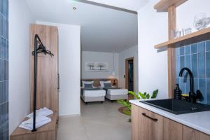 a kitchen with a sink and a living room at Psaras Apartments in Stalís +123 photos